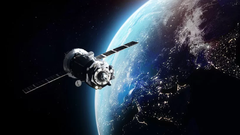 Satellite in orbit around Earth, demonstrating aerospace propulsion systems with advanced sensor technology from ES Systems.